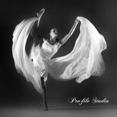 A ballet dancer in motion with a flowing white skirt